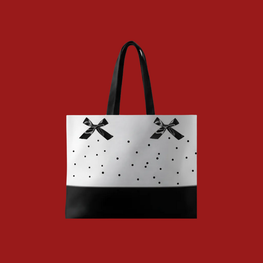 Tote bag with black bow printed design on a red background