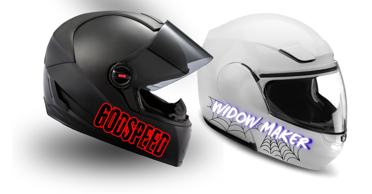 Two full-face motorcycle helmets shown on a black background: a matte black helmet with a clear visor and red GODSPEED lettering, and a glossy white helmet with a clear visor, purple 'WIDOW MAKER' lettering, and spiderweb graphics.