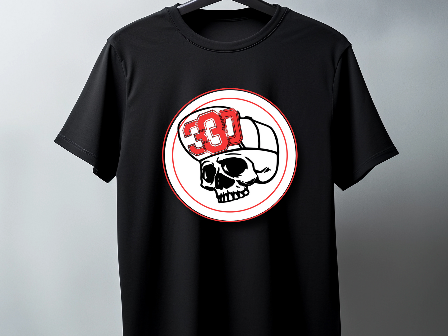 Black t-shirt with a skull and helmet graphic on a gray background